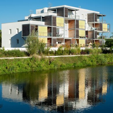 Vue de logement collectif se reflétant sur l'eau balcon métallique rapportés